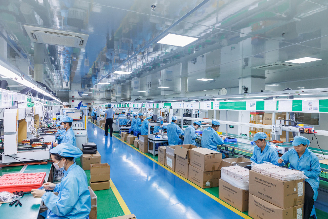 A modern factory floor showing both branded and white-label products being assembled